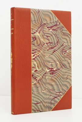 a book with a red cover sitting on top of a white table