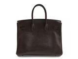 a brown leather handbag on a white background