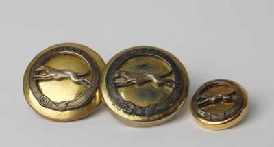 a close up of three buttons with a horse on them