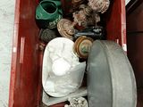 a red box filled with assorted items sitting on the floor