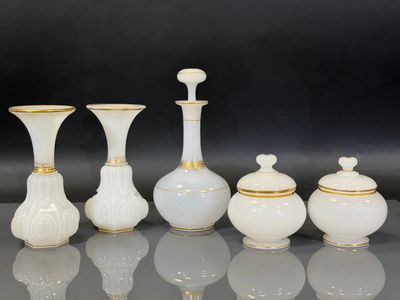 several white vases with gold trims are lined up against a black background