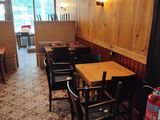 tables and chairs are lined up in a restaurant with wood paneled walls