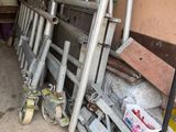 a pile of metal pipes and other items in a garage