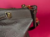 a close up of a black purse on a pink background
