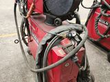 a red machine that is sitting in the parking lot