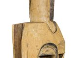 a wooden sculpture of a face on a white background