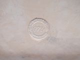 a picture of a silver plate with a medallion on it