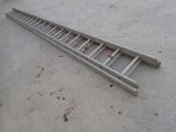 a metal ladder that is laying on the ground