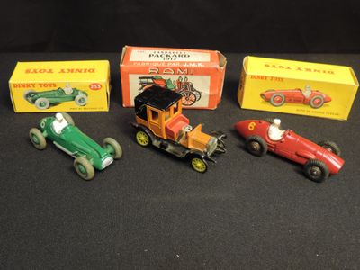 several toy cars are lined up in a row on a black surface