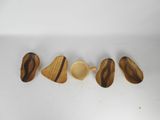 four pieces of wood are arranged in a row on a white surface