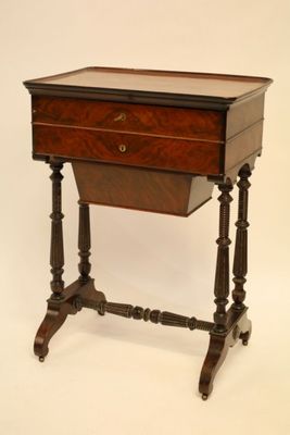 a small wooden table with a drawer on top of it