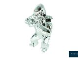 a silver figurine of a man holding a gun