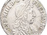 a silver coin with an image of a woman on it