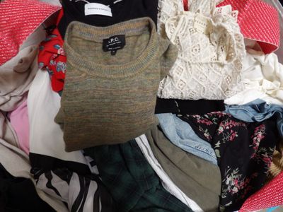 a suitcase full of clothes and clothes on the floor