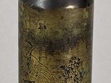 an image of a small brass bottle with a wooden lid