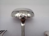 a silver spoon and fork sitting on a table