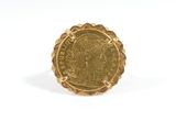 a close up of a gold coin on a white surface