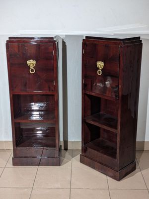 two wooden cabinets with brass handles on each of them