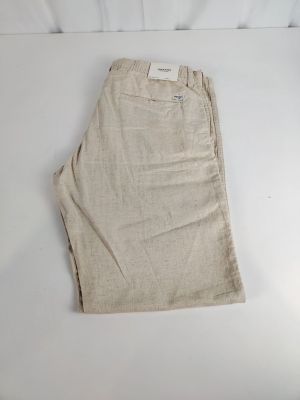 the shorts are tan colored and have a white label on the side