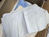 a cardboard box with a lot of clothing inside of it