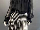 an image of a mannequin dressed in a black and white striped skirt