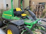 a tractor that is parked next to a pile of wood