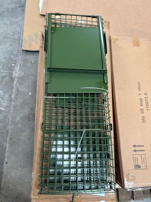 a cage that is sitting on the ground next to a box