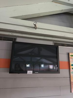 a flat screen tv mounted on the wall in a room