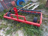 an image of a small tractor with a fork attached to it ' s back