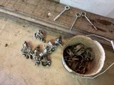a bucket full of screws and a pair of scissors on the floor