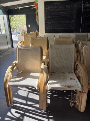 de nombreuses chaises vides dans une salle où se trouve un tableau noir accroché au mur