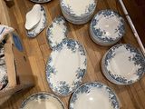 many plates and bowls sitting on the floor next to each other