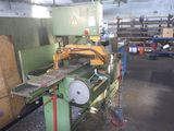 a machine that is working on a piece of wood