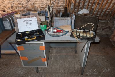 a desk with a lot of tools on it