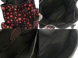 the inside of a black purse with red polka dots on it