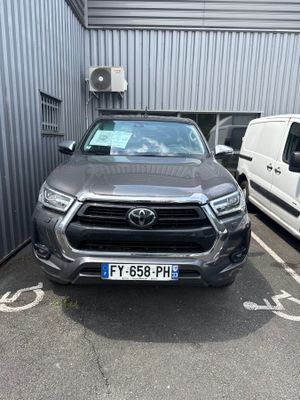 a grey toyota pickup truck parked in a parking lot