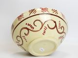a white bowl with a red design on it