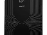 une balance électronique en noir et blanc équipée d'une horloge numérique