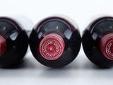 three bottles of wine sitting next to each other on a table