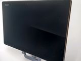 a black computer monitor sitting on top of a white table
