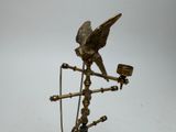 a statue of an eagle on a stand with a pipe