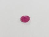 a close up of a pink stone on a white surface