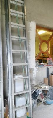 a man that is standing in a room with a ladder