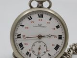 a silver pocket watch with roman numerals on it