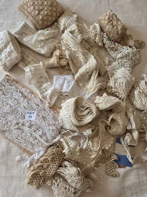 a pile of crocheted fabric on a bed