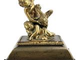 a bronze statue of a woman on a box
