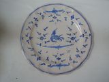 a blue and white plate with a bird on it