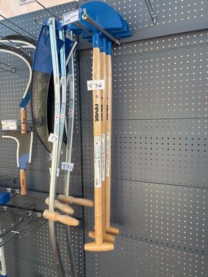 several tools hanging on the wall of a store