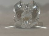 a clear glass candle holder with a flower design on it
