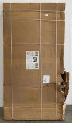 a large cardboard box sitting on the floor next to a wall